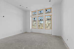 Empty room with unfinished concrete flooring