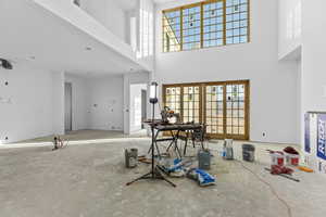 Foyer entrance with a high ceiling and french doors
