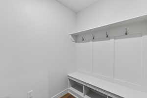 Mudroom featuring baseboards and dark wood finished floors