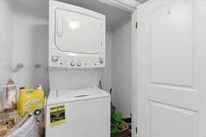 Laundry area with stacked washer and dryer