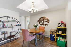 Dining space featuring parquet floors and hanging lights