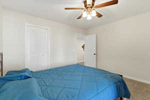 Bedroom featuring carpet, a ceiling fan, and a closet
