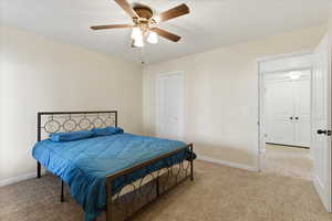 Bedroom with light carpet and ceiling fan
