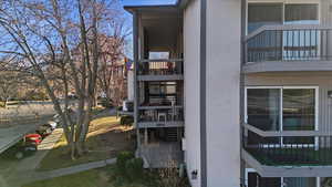 View of home's exterior with stucco siding and a balcony