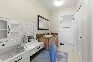 Bathroom featuring vanity and light tile patterned floors