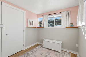 Unfurnished bedroom with light wood finished floors and a textured ceiling