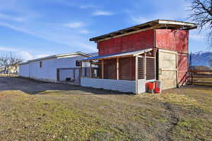 View of chicken coop with a sunroom and a mountain view