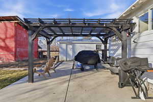 View of patio featuring a grill and a pergola