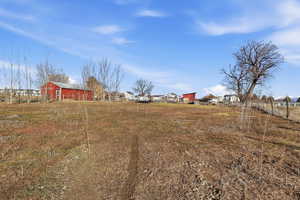 View of yard featuring an outdoor structure, a barn, and a residential view