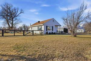 View of front of property with board and batten siding and a gate