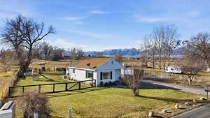 View of front facade featuring a playground, a rural view, and a mountain view