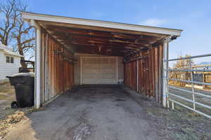 Garage featuring asphalt driveway