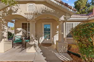 Doorway to property featuring stucco siding