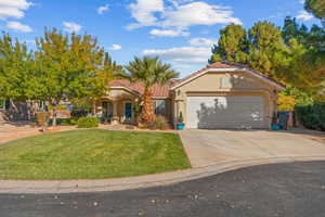 Mediterranean / spanish-style house featuring stucco siding, concrete driveway, an attached garage, a front lawn, and a tiled roof