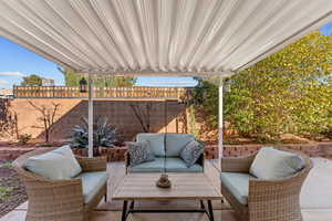 Fenced backyard with an outdoor lounge area and a patio