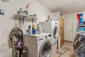 Laundry room featuring washer and clothes dryer and unfinished concrete flooring