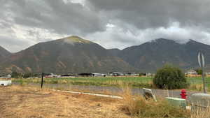 View of mountain backdrop featuring rural landscape