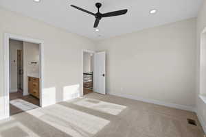 Unfurnished bedroom with ceiling fan, light carpet, recessed lighting, and connected bathroom