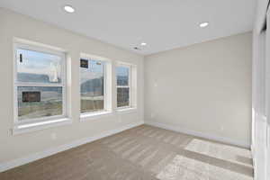 Carpeted empty room with baseboards and recessed lighting