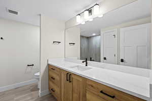 Bathroom featuring vanity and wood tiled floors