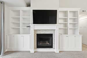 Livingroom fireplace with built in cabinets