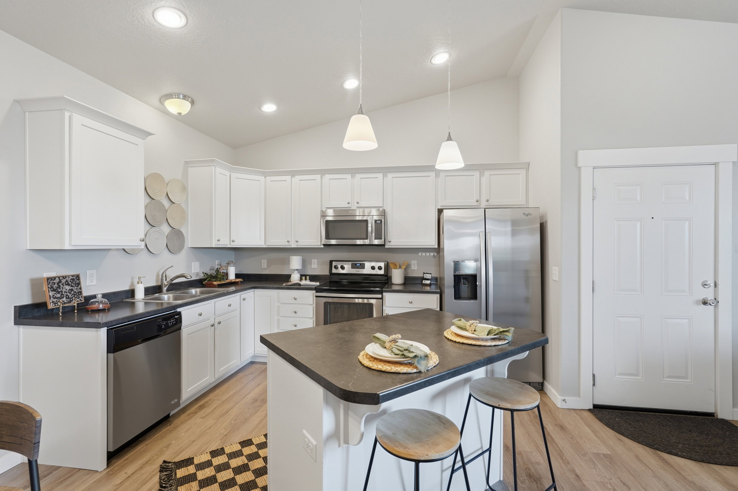 Clean, white kitchen cabinets with refrigerator included