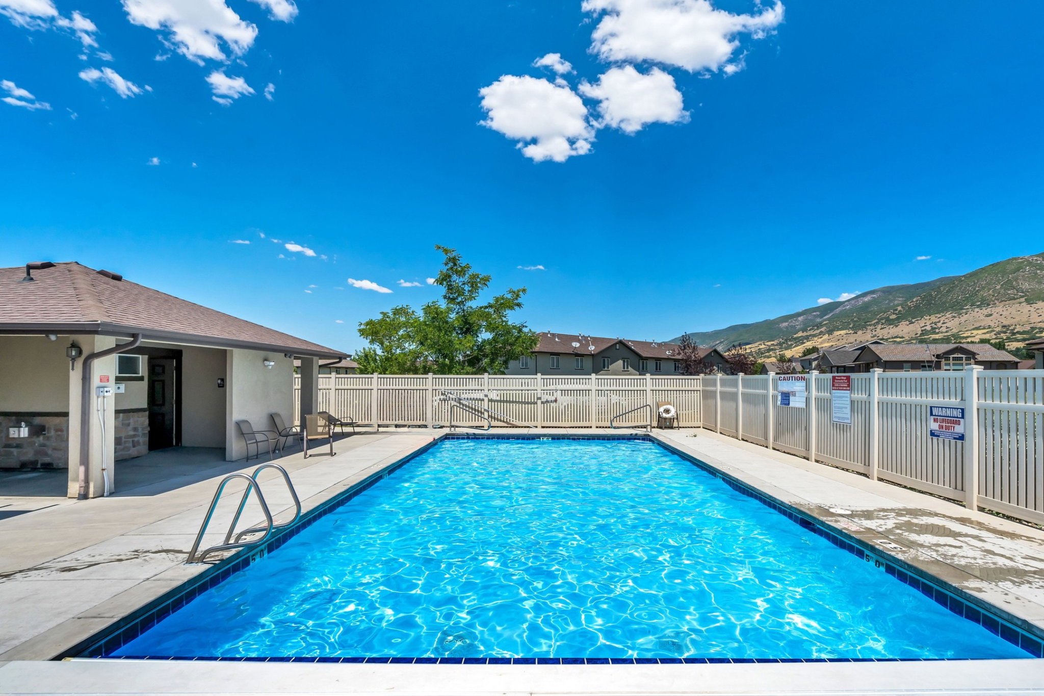 Outdoor swimming pool with and perimeter fencing
