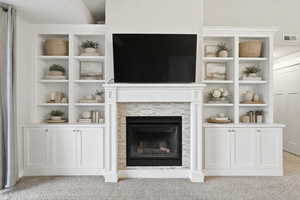 Virtually staged living room fireplace with built in cabinets