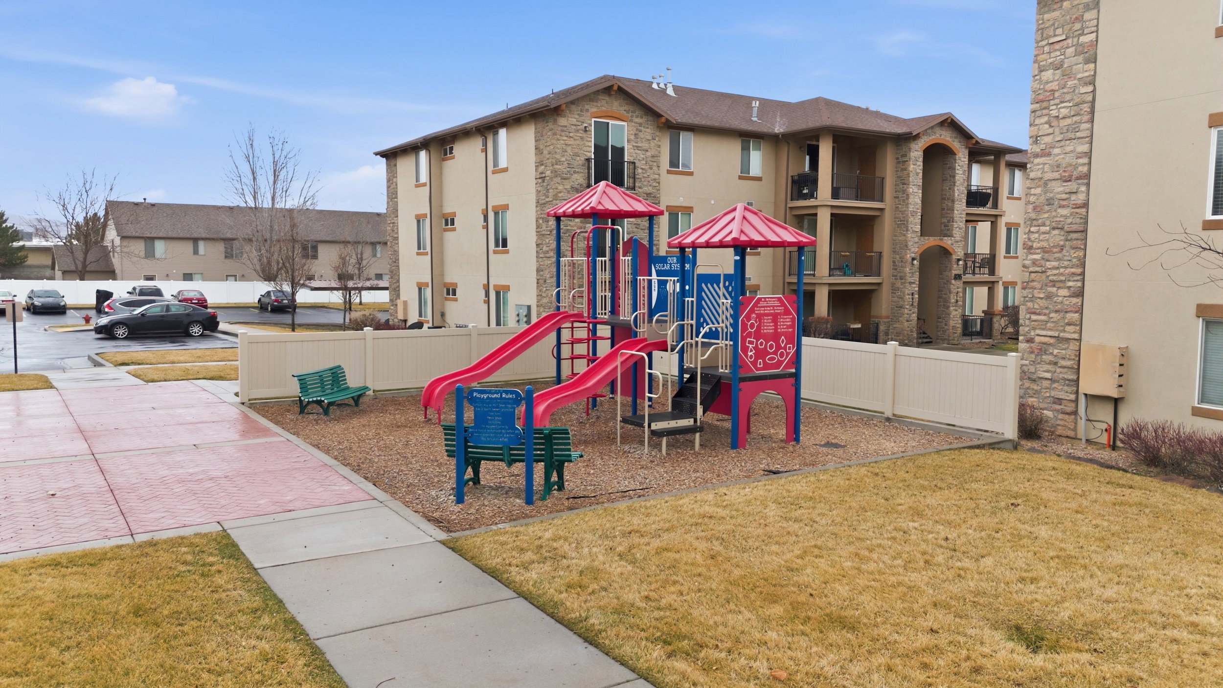 Outdoor playground with red slides and blue accents