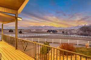 Wooden terrace featuring a mountain view and a rural view