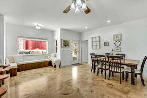 Dining area with a ceiling fan and recessed lighting