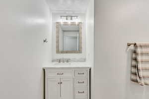 Bathroom with vanity and a textured ceiling