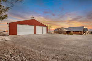 Garage at dusk featuring a garage