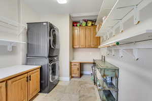Laundry room with cabinet space and stacked washer / dryer