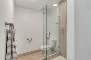 Bathroom with toilet and a stall shower