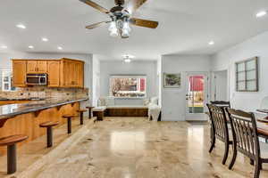 Dining room with recessed lighting and a ceiling fan