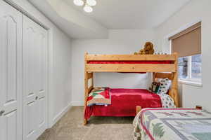 Bedroom featuring carpet and a closet