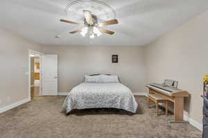 Bedroom featuring light colored carpet, a ceiling fan, and a textured ceiling