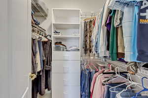 Primary bedroom walk in closet