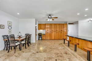 Dining area featuring a ceiling fan and recessed lighting
