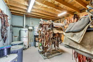 Unfinished below grade area featuring strapped water heater