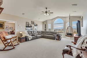 Living area with carpet floors, vaulted ceiling, and ceiling fan with amazing valley view.
