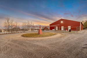 View of dirt / gravel driveway with an outbuilding