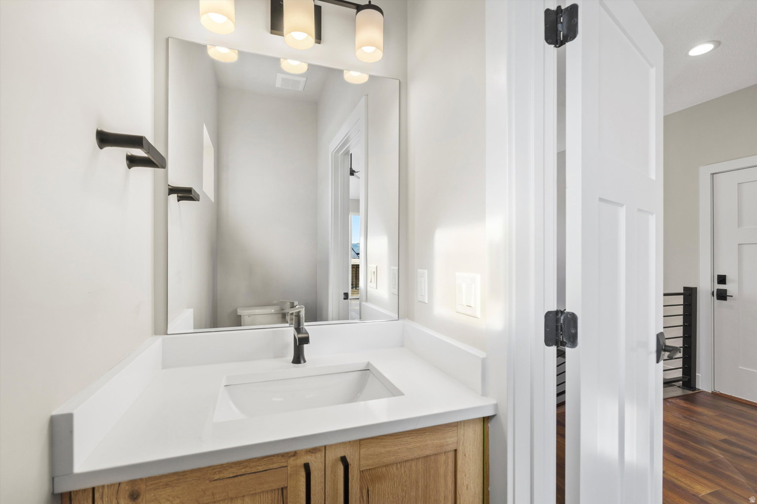 Bathroom featuring vanity and dark wood-style floors