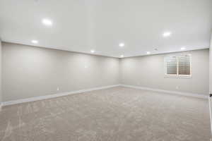 Finished below grade area featuring light carpet and recessed lighting