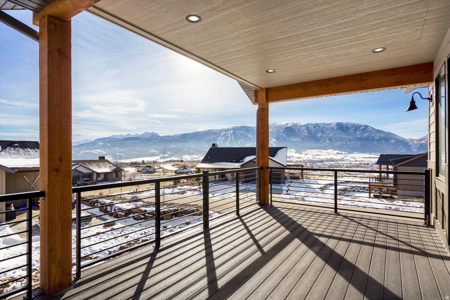 Snow covered deck featuring a mountain view