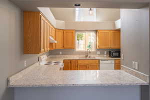 Kitchen with white appliances and light stone countertops