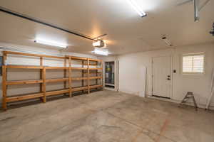 Garage with gas water heater and a garage door opener