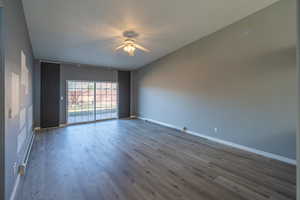 Spare room with a baseboard radiator, baseboard heating, light wood finished floors, ceiling fan, and a textured ceiling