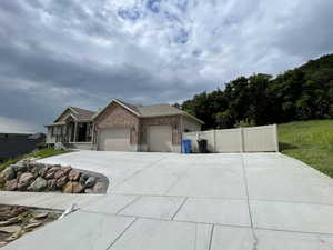 Ranch-style house with brick siding, a garage, and driveway